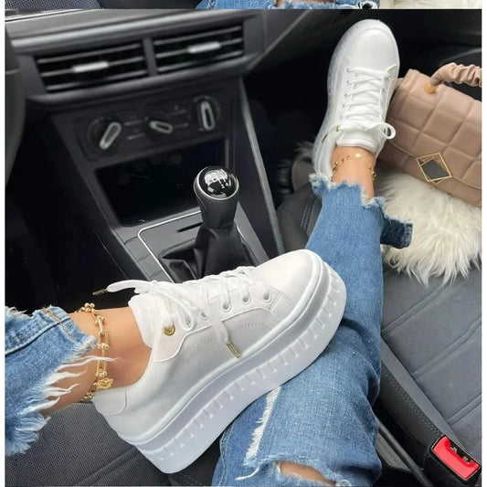 Women's white platform sneakers lace-up walking shoes worn in a car
