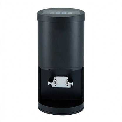 Front view of a black automatic espresso tamper with digital control panel and silver portafilter holder.