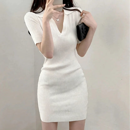 Woman wearing a short-sleeve white ribbed knit polo mini dress with a V-neckline.
