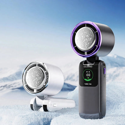 Two handheld turbo cooling fans with ice compress plates and digital speed displays in a snowy setting.
