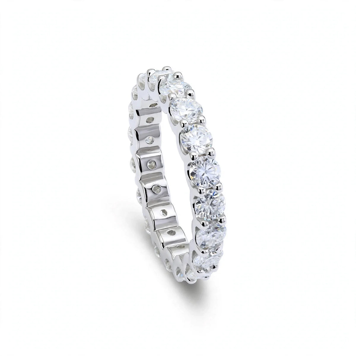 Silver full eternity ring featuring round stones and side text labels.