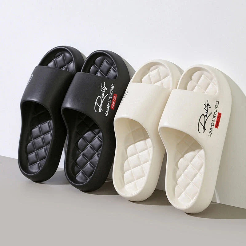Two pairs of thick platform slide sandals in black and off-white with quilted footbeds.