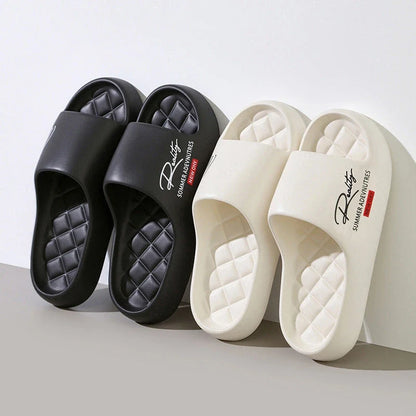 Two pairs of thick platform slide sandals in black and off-white with quilted footbeds.