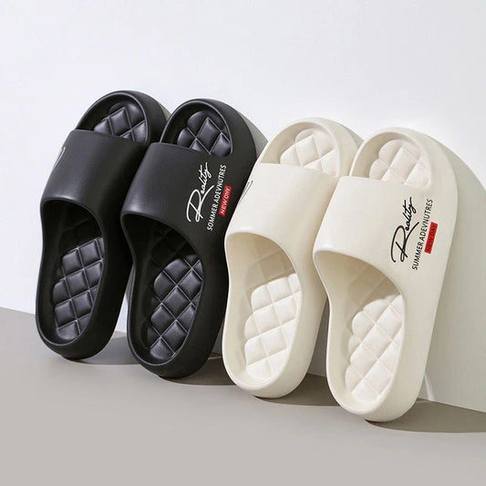 Two pairs of thick platform slide sandals in black and off-white with quilted footbeds.