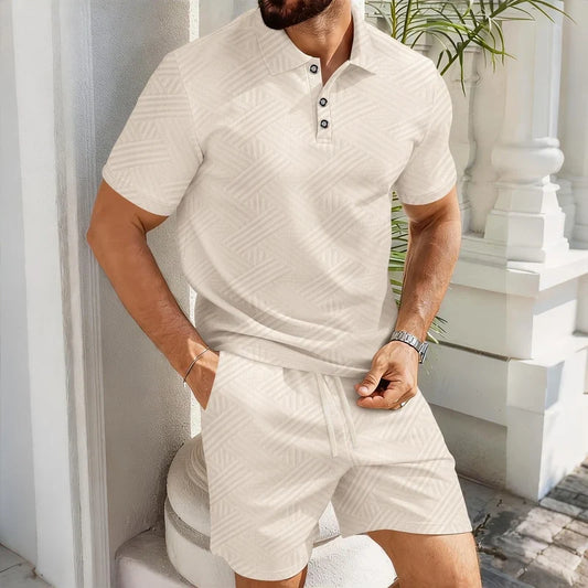 Man wearing a cream-colored jacquard polo shirt and matching drawstring shorts with a geometric pattern.