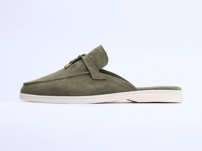 Olive green suede mule with a flat white sole and tassel detail on the upper, side view.