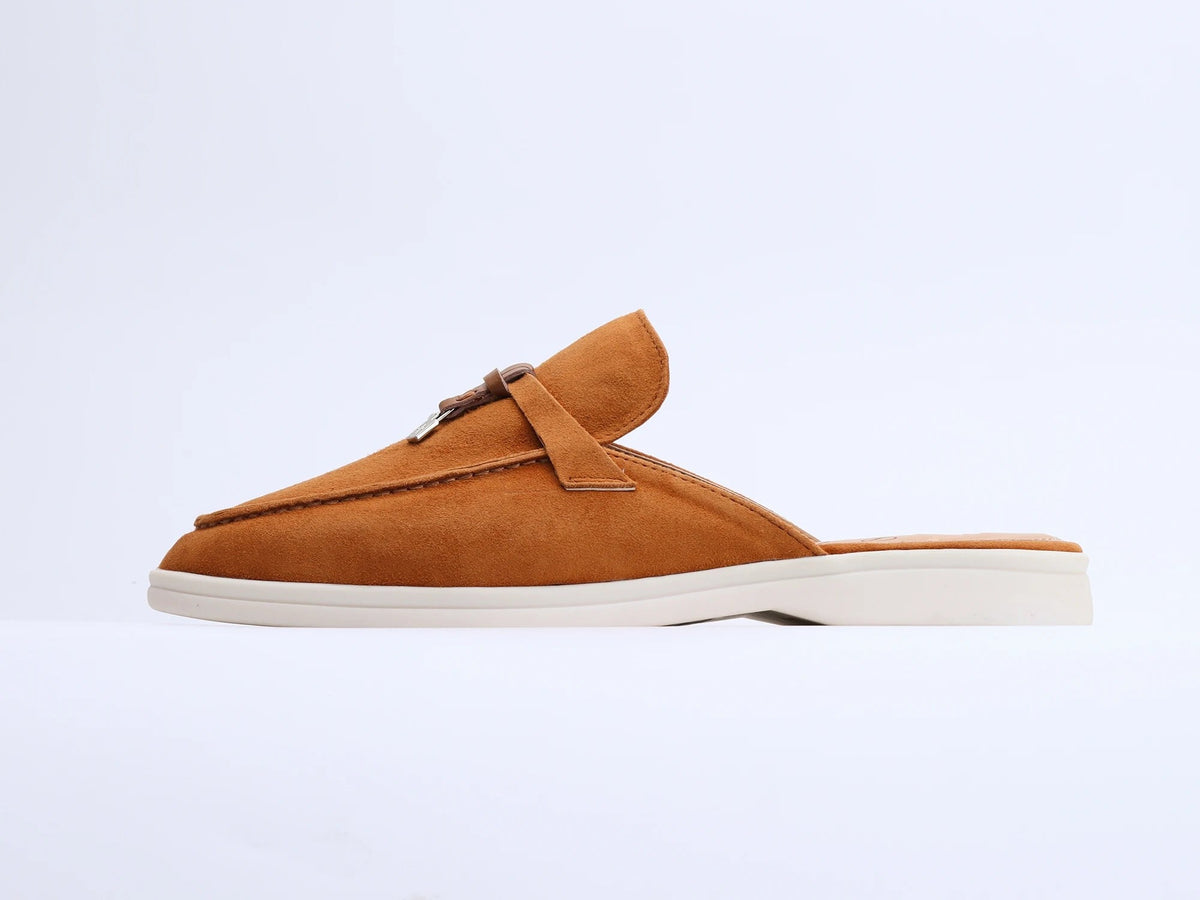 Tan suede mule with white flat sole and side strap detail, side view