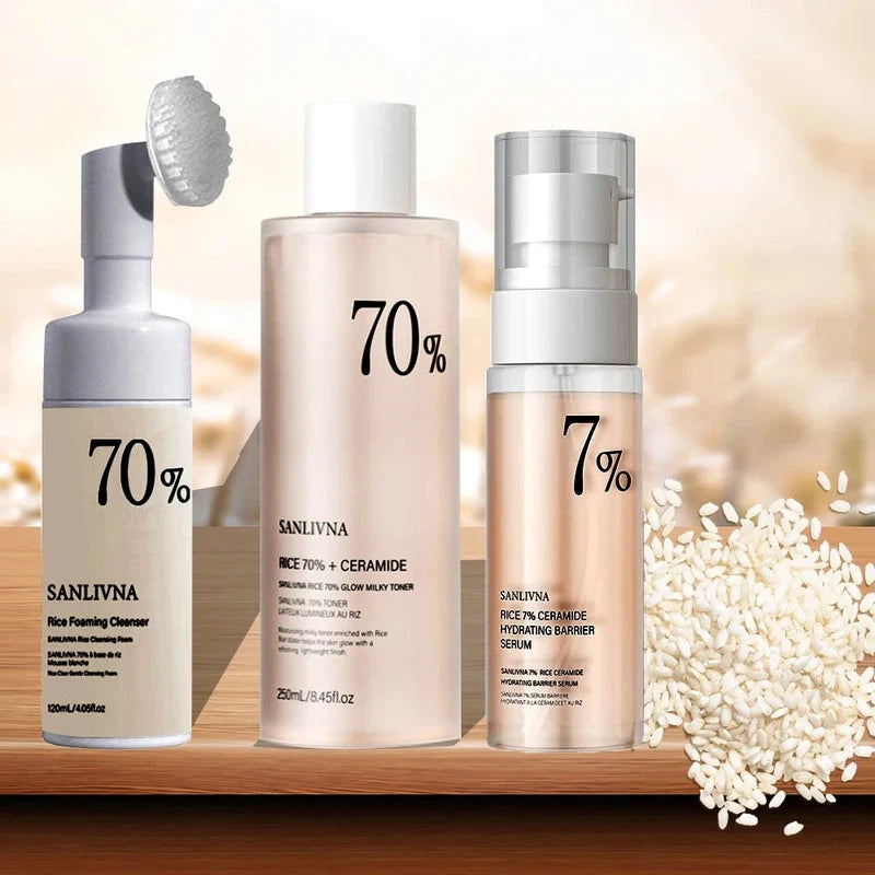Skincare set featuring a foaming cleanser, milky toner, and serum next to white rice grains.