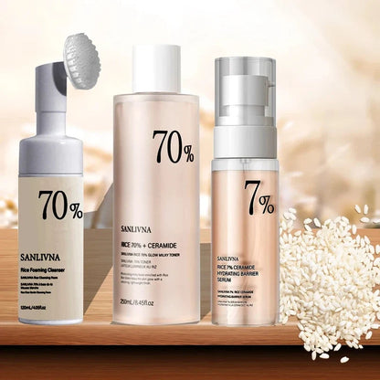 Skincare set featuring a foaming cleanser, milky toner, and serum next to white rice grains.