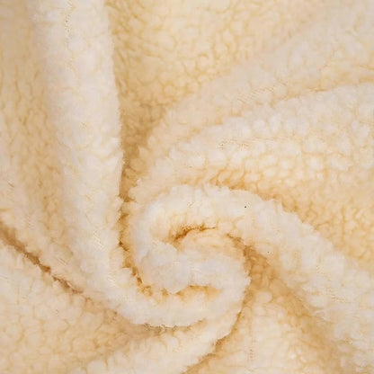 Close-up of soft beige sherpa fleece fabric texture.