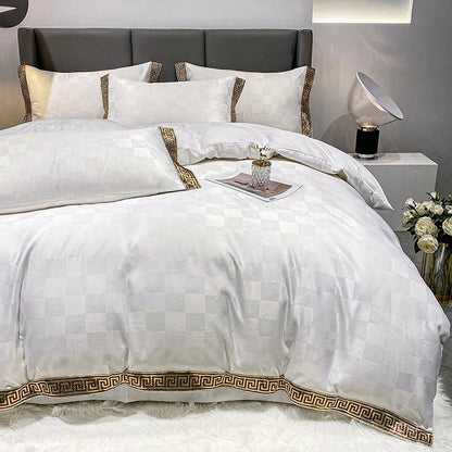 White checkered bed sheet set with a quilt cover and a gold geometric key border on pillows and duvet.