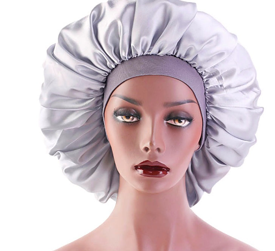 Silver satin hair bonnet sleep cap for overnight protection with wide band on mannequin