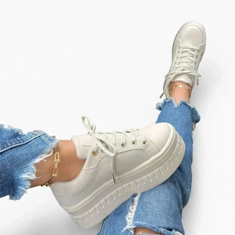 Women's white platform sneakers lace-up walking shoes worn in a car