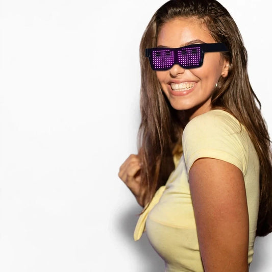 Smiling woman wearing black programmable LED party glasses showing purple light patterns.
