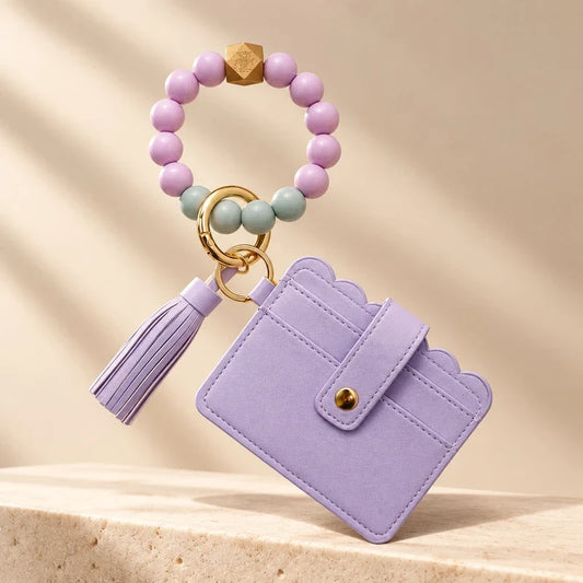 Purple beaded wristlet keychain with matching tassel and scalloped card wallet.