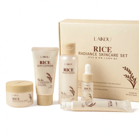 Rice skincare routine set with cleanser, toner, serum, cream, and eye cream in front of its matching box.