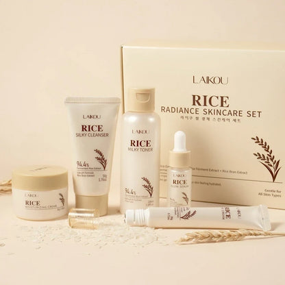 Skincare set with cream, cleanser, toner, serum, and eye cream tubes in front of a box.