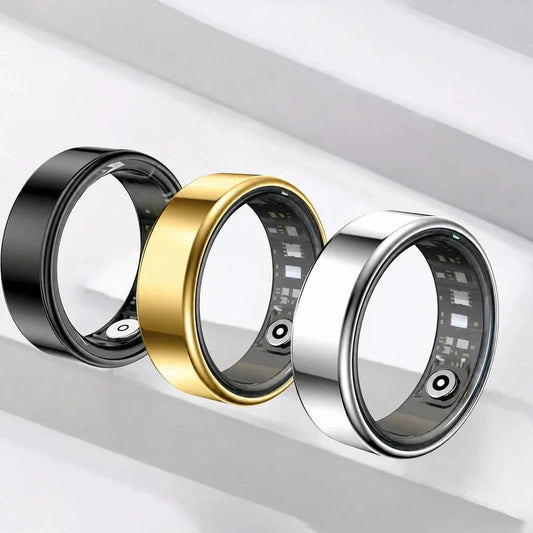 Three smart fitness rings in black, gold, and silver on white.