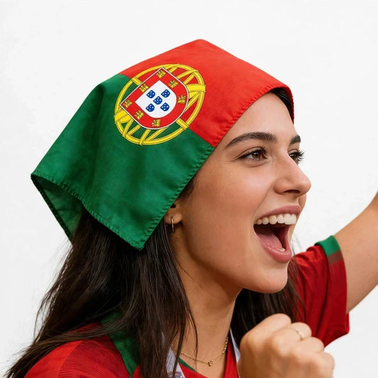 Smiling fan cheering with a red, green, and gold flag-print scarf tied on the head.