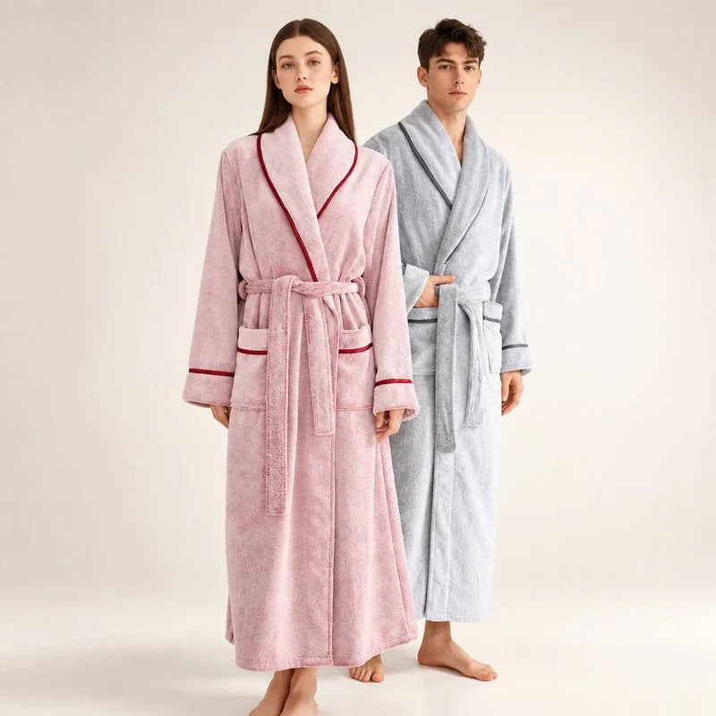 A woman and a man wearing long flannel bathrobes with matching tie belts and shawl collars.