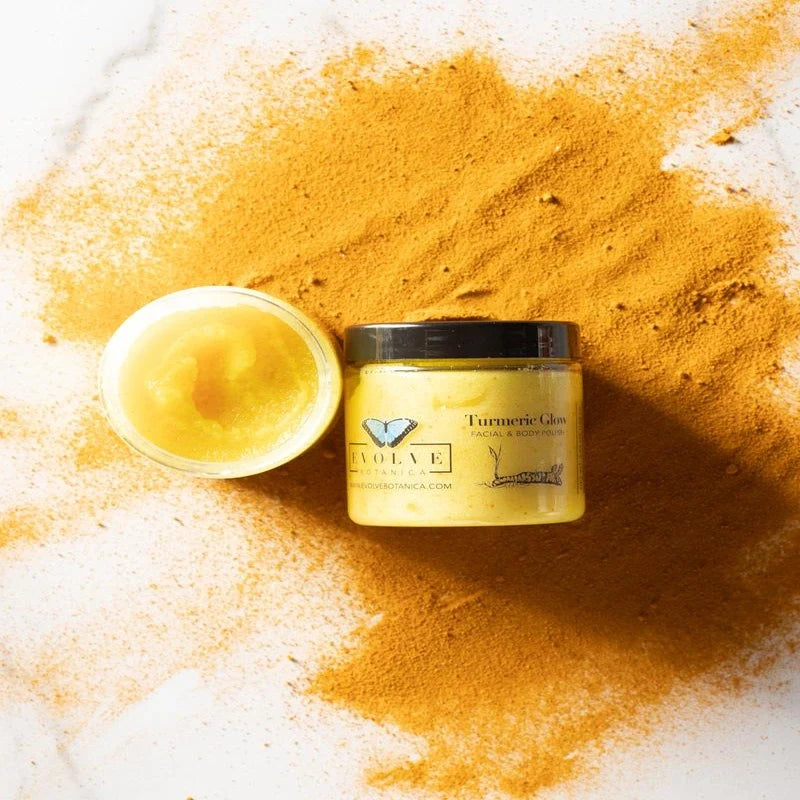 A jar of turmeric scrub and an open container of yellow polish on a background of turmeric powder.