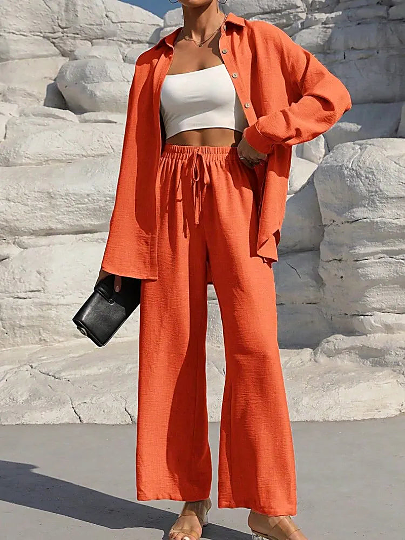 Women lounge set featuring a long sleeve button down shirt and high waisted wide leg pants with a drawstring waistband