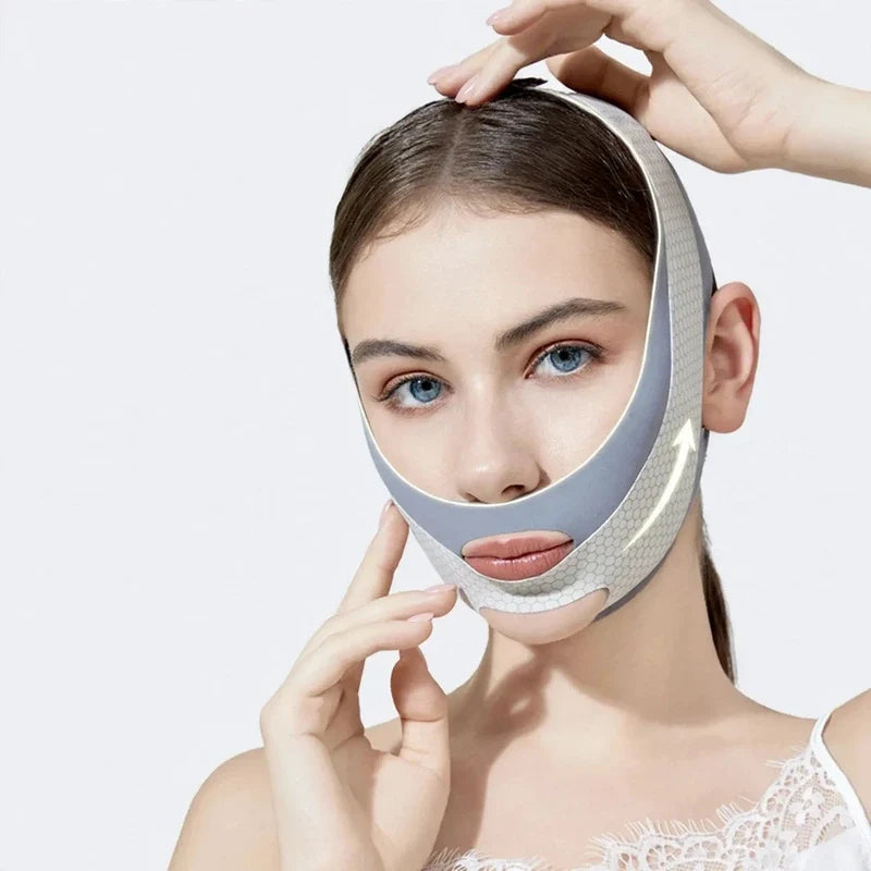 Woman wearing a grey V-line lifting face mask strap wrapping under her chin and securing over her head.