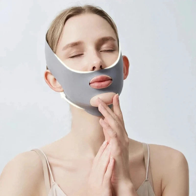 Woman wearing a grey V-line lifting face mask covering chin and jawline.