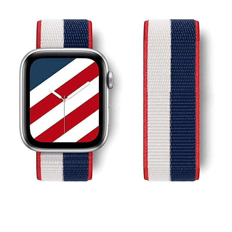 Silver smartwatch with red, white, and blue striped nylon band next to a matching spare band.