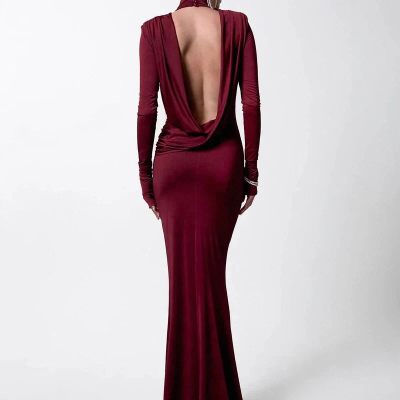 Burgundy long-sleeve maxi dress with a cowl backless design and high neck.