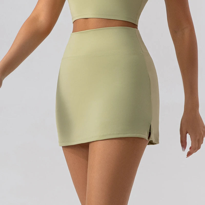 Close-up of a high-waist light green athletic tennis skirt with built-in shorts.
