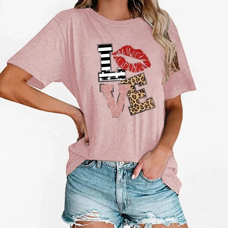 Pink short-sleeve t-shirt with a LOVE graphic featuring striped, glitter, and leopard print letters and red lips.