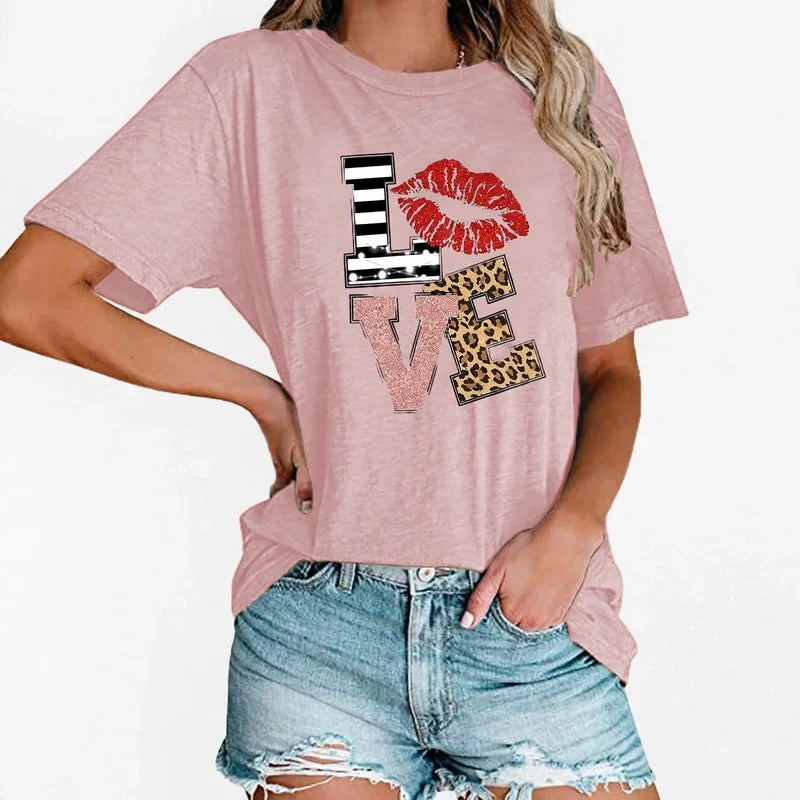 Pink short-sleeve t-shirt with a LOVE graphic featuring striped, lip, glitter, and leopard print letters