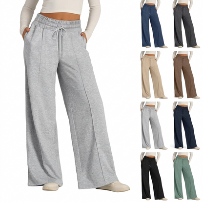 Light gray wide-leg fleece pants with drawstring waist and center-seam detail, worn with white top and sneakers