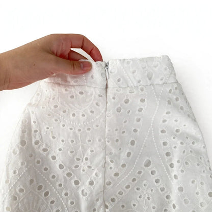Close-up of white eyelet skirt zipper closure