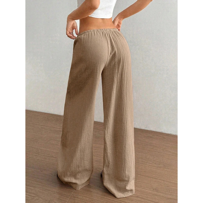 Rear view of a person wearing textured brown wide-leg pants with an elastic waist.