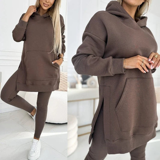 Woman wearing a brown hooded sweatshirt with side slits and matching leggings.