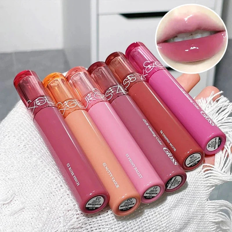 Six colorful lip gloss tubes held in a hand, with an inset showing glossy pink lips.