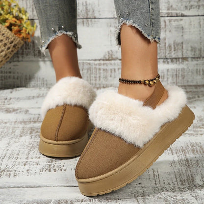 Tan platform slippers with white faux-fur trim worn with cropped distressed jeans.