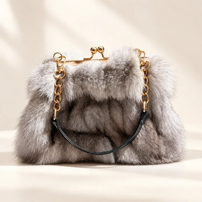 Fluffy grey fur evening handbag with a gold-tone kiss-lock frame and chain handle.