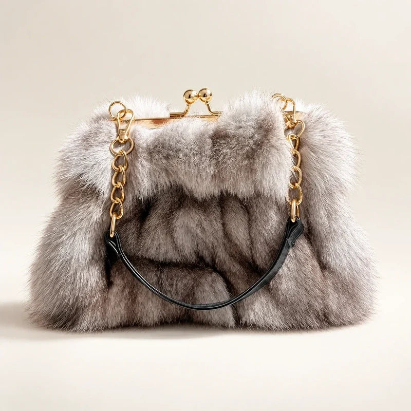 Fluffy gray faux fur evening handbag with a gold kiss lock frame and chain strap.