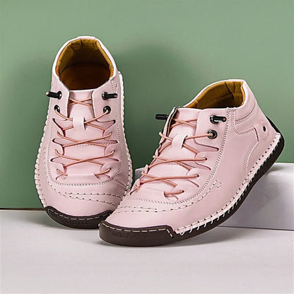 Pink casual shoes with lace-up bungee cords, contrast white stitching, and dark brown soles.