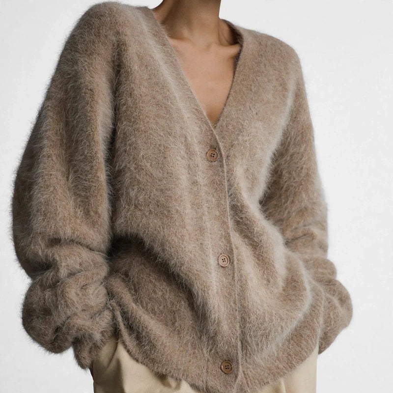 Tan fuzzy oversized V-neck cardigan with buttons and long sleeves.