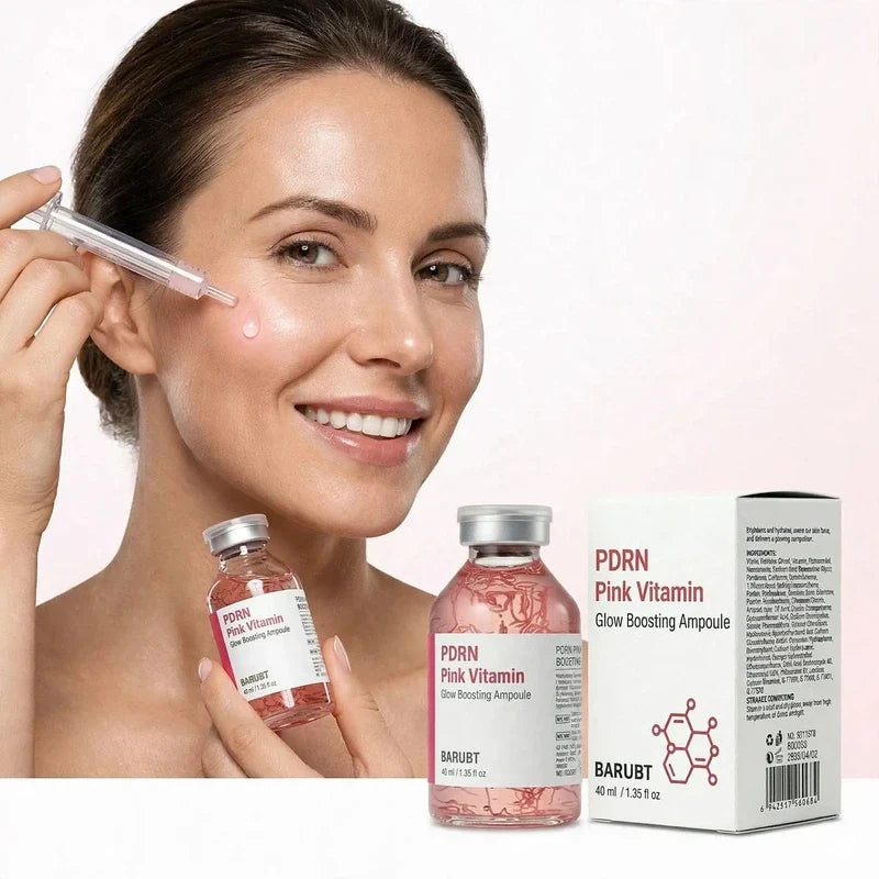 Woman applying pink facial serum with a dropper beside product bottles and packaging