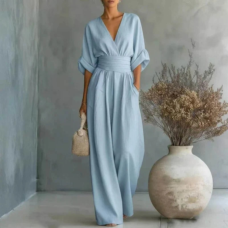 Women's tailored jumpsuit with a V-neck, wide leg, and waist sash