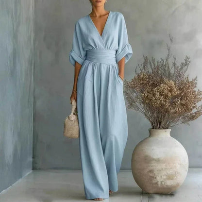 Women's tailored jumpsuit with a V-neck, wide leg, and waist sash