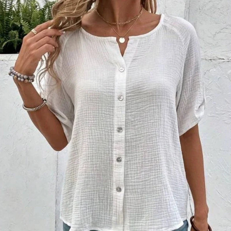 White short-sleeve button-up blouse with textured fabric and a round neckline.