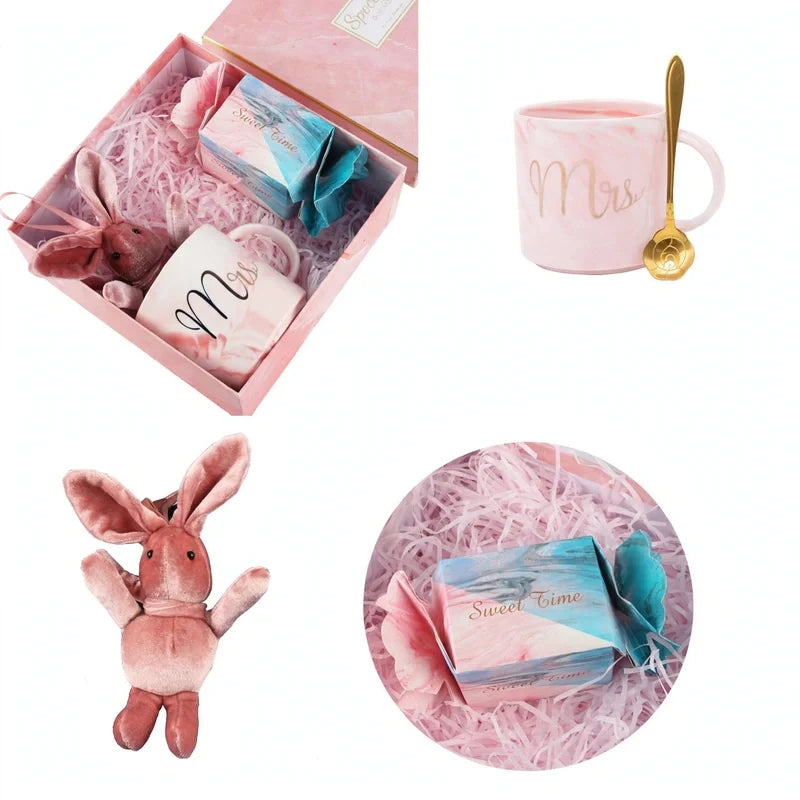 Pink gift box set with a pink mug, gold spoon, plush bunny, and wrapped soap.