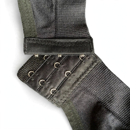 Close-up of a black bra back band with adjustable hook and eye closures.