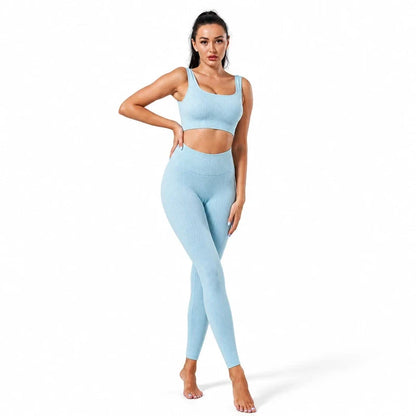 Woman wearing a light blue ribbed yoga crop top and matching high waist leggings.